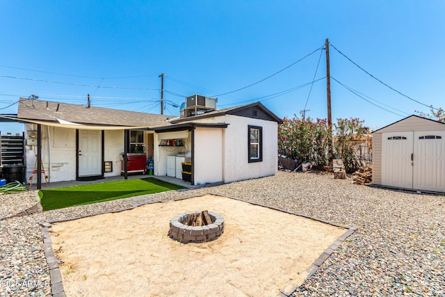 5044 N 18th Ave, Phoenix, AZ 85015 - back of property with an outdoor fire pit, a patio, and a storage shed