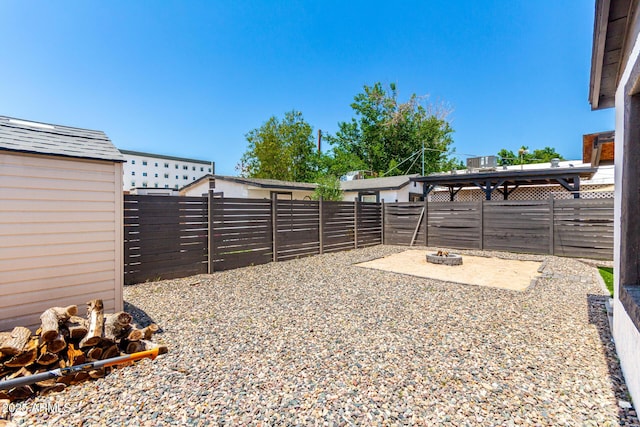 5044 N 18th Ave, Phoenix, AZ 85015 - fenced backyard with a fire pit and an outbuilding