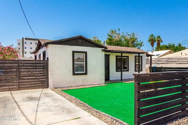 5044 N 18th Ave, Phoenix, AZ 85015 - single story home with stucco siding, a gate, and roof with shingles