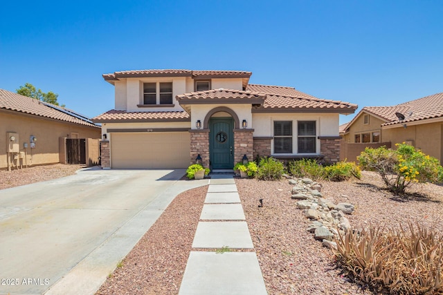 597 S 221st Dr, Buckeye, AZ 85326 - mediterranean / spanish-style house featuring stucco siding, stone siding, a tile roof, concrete driveway, and fence
