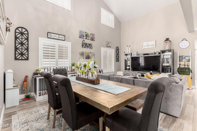 597 S 221st Dr, Buckeye, AZ 85326 - dining area with high vaulted ceiling, light wood-style floors, and baseboards