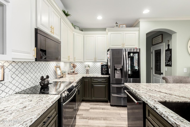 597 S 221st Dr, Buckeye, AZ 85326 - kitchen with appliances with stainless steel finishes, white cabinets, light stone countertops, recessed lighting, and decorative backsplash