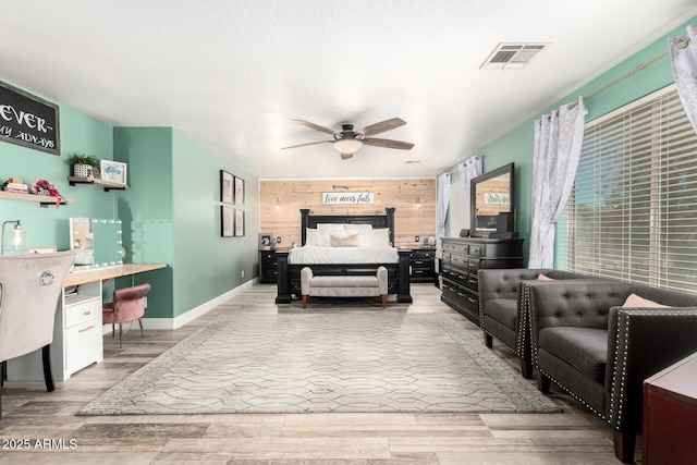 597 S 221st Dr, Buckeye, AZ 85326 - bedroom featuring wood walls, an accent wall, wood finished floors, baseboards, and an office area
