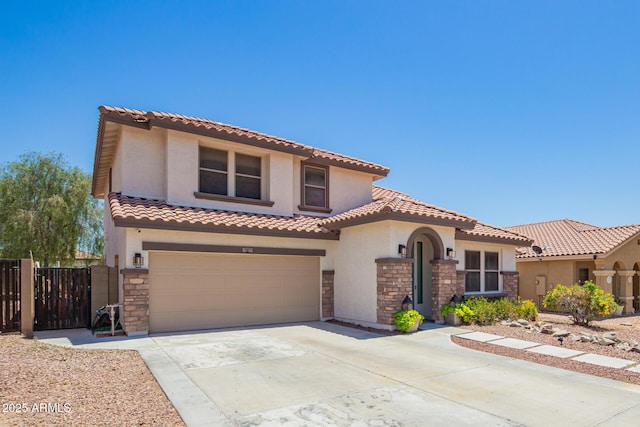 597 S 221st Dr, Buckeye, AZ 85326 - mediterranean / spanish house with stone siding, concrete driveway, fence, stucco siding, and a garage
