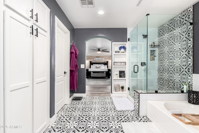 597 S 221st Dr, Buckeye, AZ 85326 - bathroom with ensuite bathroom, a ceiling fan, a stall shower, a garden tub, and tile patterned floors