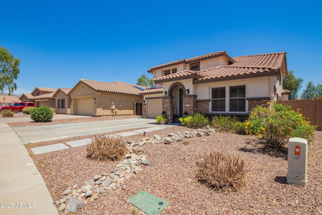 597 S 221st Dr, Buckeye, AZ 85326 - mediterranean / spanish-style home featuring a garage, stucco siding, stone siding, a tile roof, and driveway