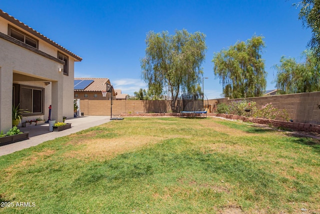 597 S 221st Dr, Buckeye, AZ 85326 - view of yard featuring a trampoline and a patio