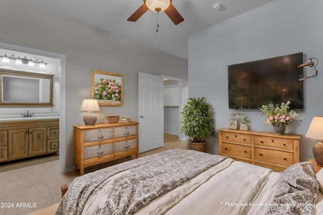 tiled bedroom featuring ensuite bathroom, sink, and ceiling fan