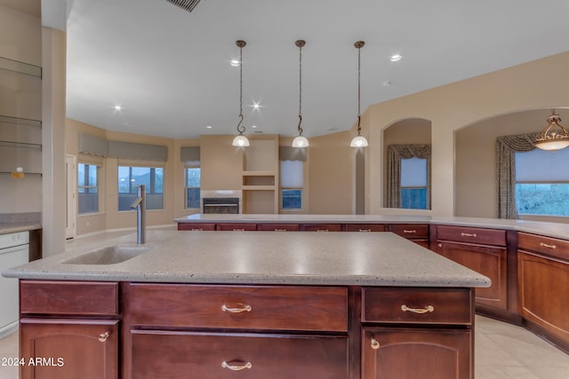 kitchen featuring white dishwasher, plenty of natural light, sink, and hanging light fixtures