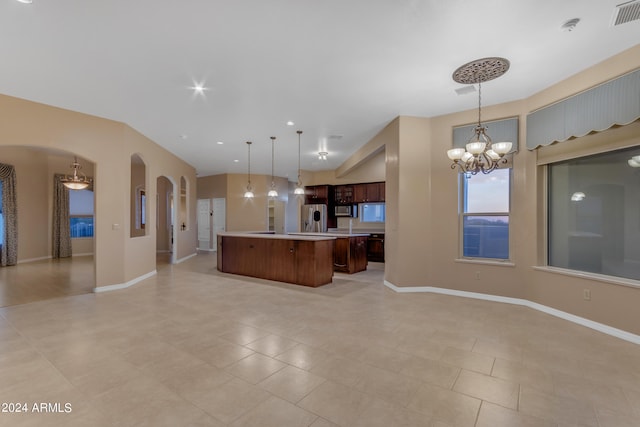 kitchen featuring a center island, an inviting chandelier, stainless steel fridge, pendant lighting, and light tile patterned flooring