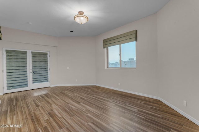 unfurnished room with wood-type flooring