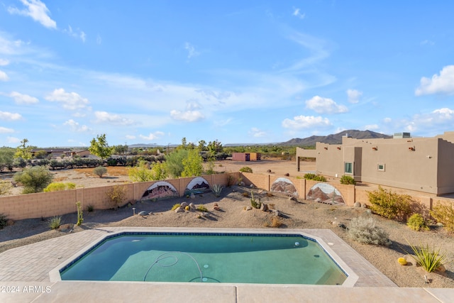 view of pool featuring a mountain view and a patio area