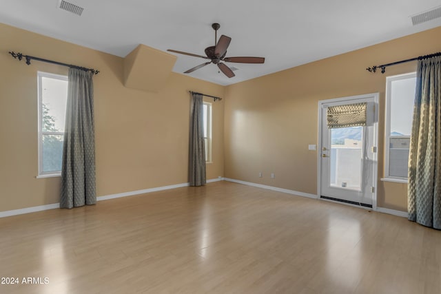 empty room featuring ceiling fan and light hardwood / wood-style floors