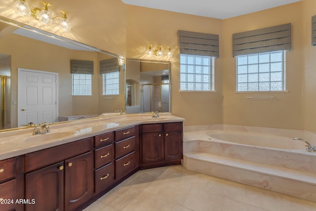 bathroom with shower with separate bathtub, vanity, and tile patterned floors