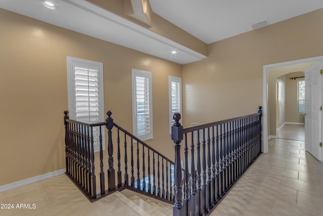 stairway with tile patterned floors and a healthy amount of sunlight