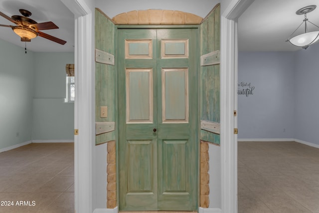 foyer with light tile patterned floors and ceiling fan