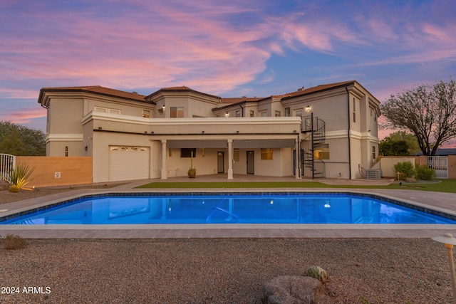 view of pool at dusk