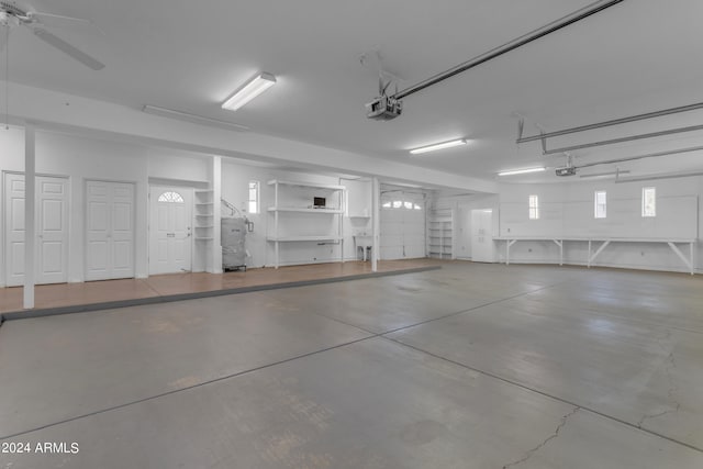 garage featuring a garage door opener and ceiling fan