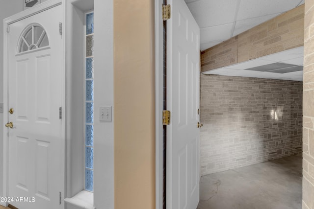 bathroom featuring a drop ceiling and concrete floors