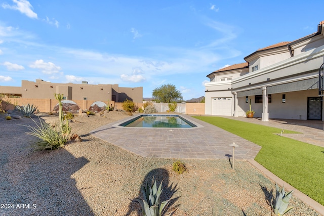 view of pool with a yard