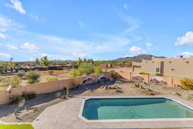 view of pool featuring a mountain view and a patio area