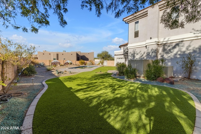 view of yard with a fenced in pool