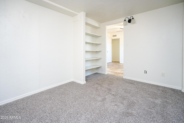 empty room with baseboards and carpet flooring