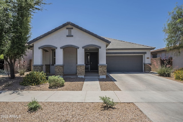 22463 E Desert Spoon Dr, Queen Creek, AZ 85142 - view of front facade featuring a garage, concrete driveway, stucco siding, stone siding, and a tiled roof