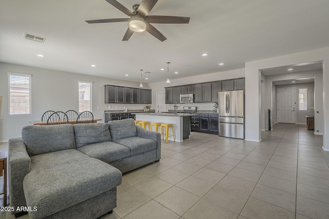 22463 E Desert Spoon Dr, Queen Creek, AZ 85142 - living room with light tile patterned floors, a ceiling fan, recessed lighting, and baseboards