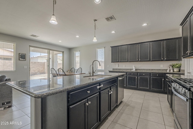 22463 E Desert Spoon Dr, Queen Creek, AZ 85142 - kitchen with a sink, appliances with stainless steel finishes, light tile patterned floors, a kitchen island with sink, and recessed lighting