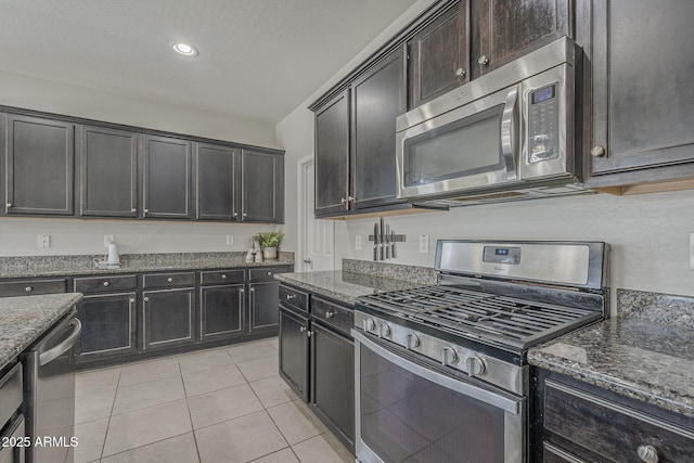 22463 E Desert Spoon Dr, Queen Creek, AZ 85142 - kitchen featuring appliances with stainless steel finishes, dark stone counters, light tile patterned flooring, and recessed lighting