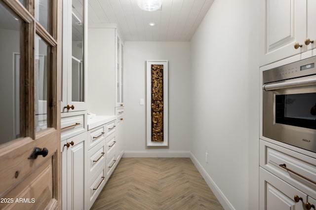 walk in closet with light parquet flooring