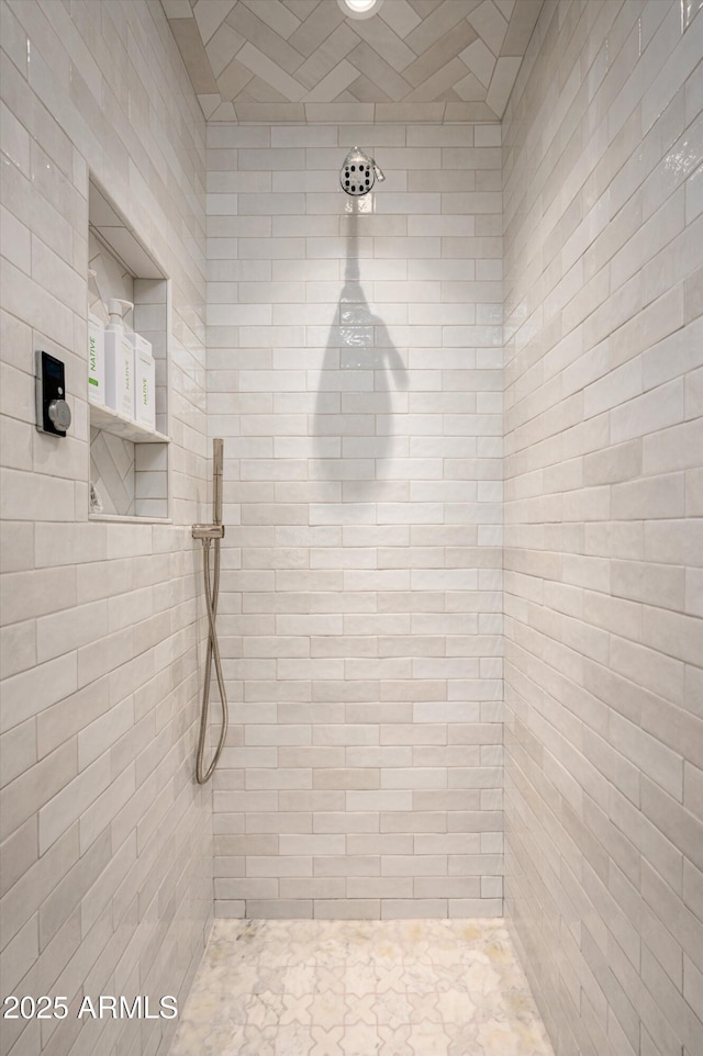 bathroom with a tile shower