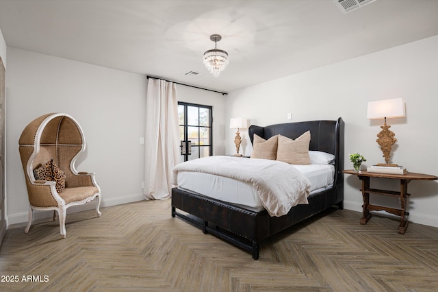 bedroom featuring an inviting chandelier, parquet floors, and access to exterior