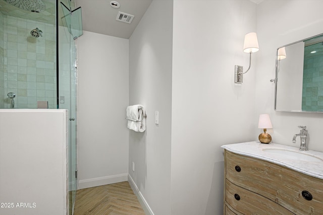 bathroom with vanity, parquet flooring, and an enclosed shower