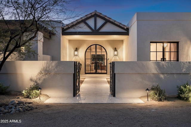 view of exterior entry at dusk