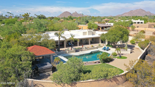 view of swimming pool featuring a mountain view and a patio area