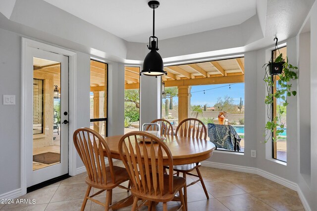 dining room with a wealth of natural light and light tile patterned floors