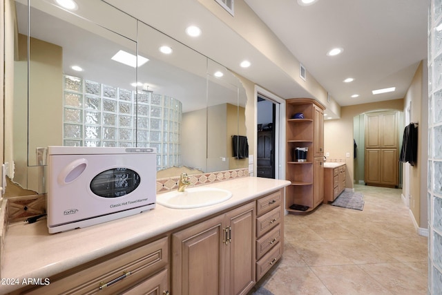 bathroom featuring washer / clothes dryer, vanity, and tile patterned floors