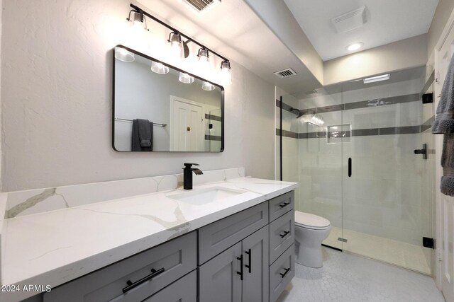 bathroom with vanity, toilet, and walk in shower