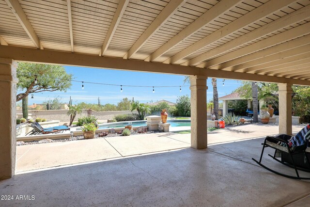 view of patio / terrace with a fenced in pool