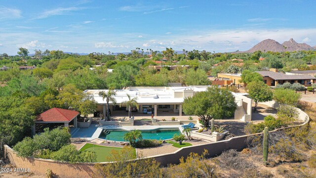 rear view of house with a mountain view and a patio area