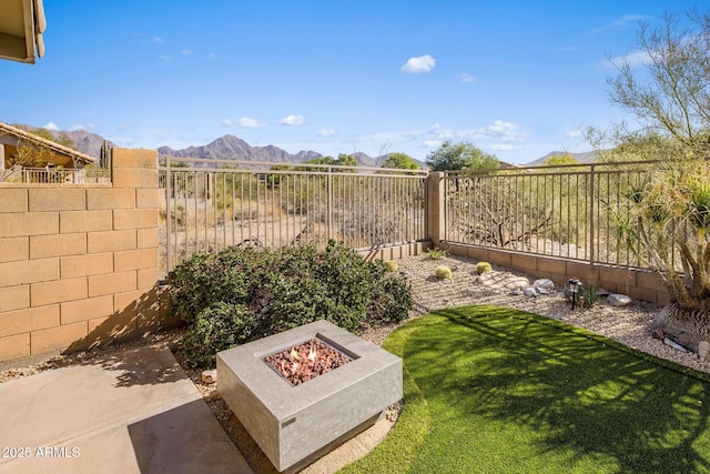 view of yard with a mountain view and a fire pit