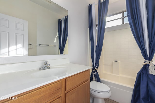 full bathroom with vanity, shower / tub combo, and toilet