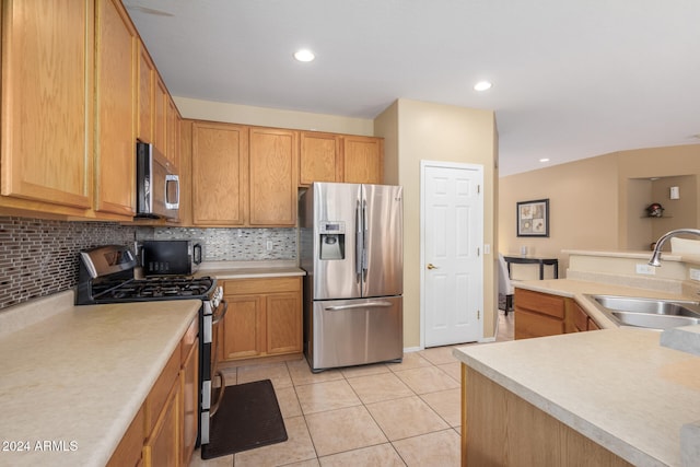 kitchen with sink, decorative backsplash, stainless steel appliances, and light tile patterned floors