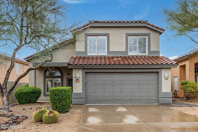 mediterranean / spanish-style house featuring a garage, driveway, and stucco siding