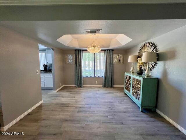 19014 N 91st Dr, Peoria, AZ 85382 - unfurnished dining area featuring a chandelier, baseboards, and wood finished floors