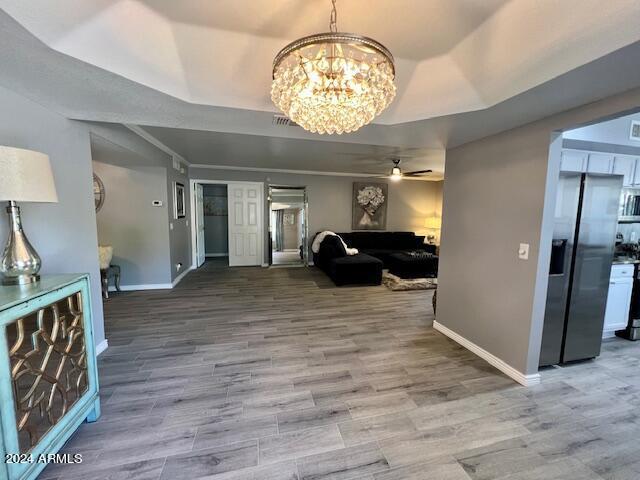 19014 N 91st Dr, Peoria, AZ 85382 - living room with ceiling fan, baseboards, a raised ceiling, a chandelier, and wood finished floors