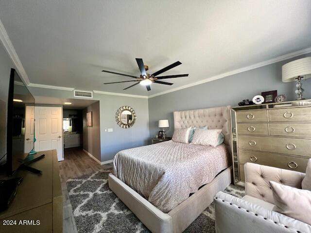 19014 N 91st Dr, Peoria, AZ 85382 - bedroom featuring ornamental molding, wood finished floors, baseboards, and ceiling fan