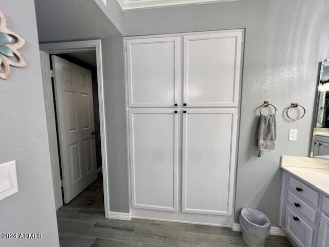 19014 N 91st Dr, Peoria, AZ 85382 - bathroom with baseboards, vanity, and wood finished floors